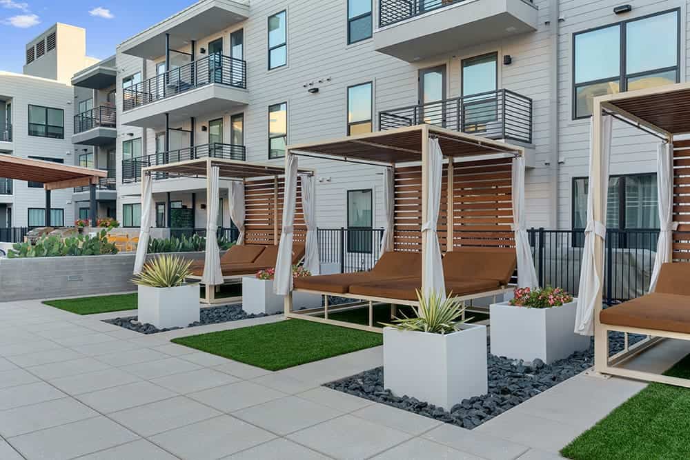 Outdoor lounge chairs with cabanas at Parkside at Mueller, Austin, TX.