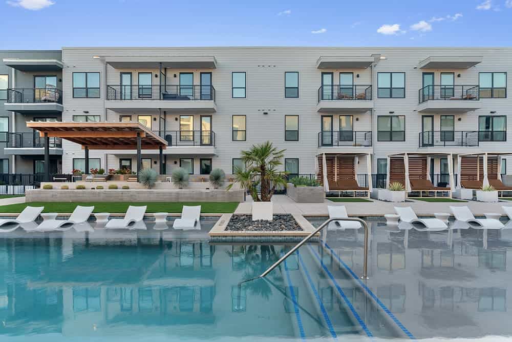 Apartment complex at Parkside at Mueller with pool and outdoor amenities.