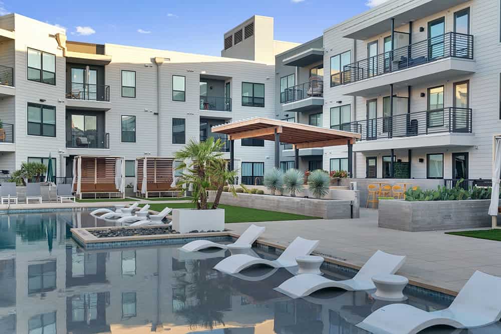 Modern apartment complex at Parkside at Mueller with pool and outdoor amenities.
