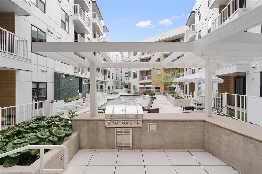 Outdoor grilling area in a contemporary apartment complex.